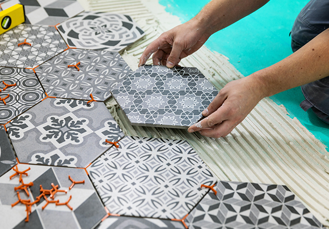 Man Laying Hexagon tiles on floor - Asian Paints