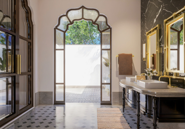 Ornate Bathroom with Gold Faucets