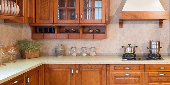 A Kitchen with Wooden Cabinets, indicating to explore the premium wood finishes from the Woodtech range