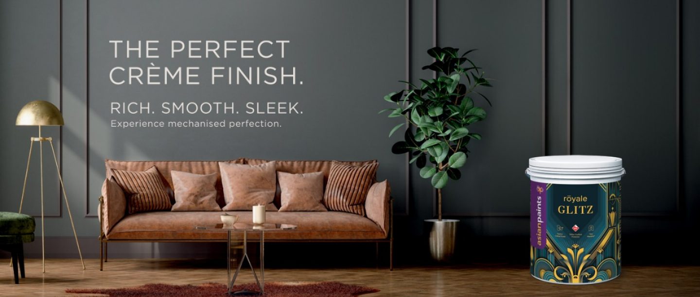 Banner image of a crème finish sofa with gold accents and grey wall