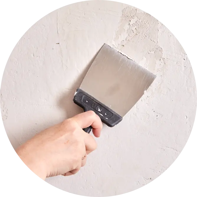 Application of putty on the wall using a painting brush. Asian Paints wall putty collection.