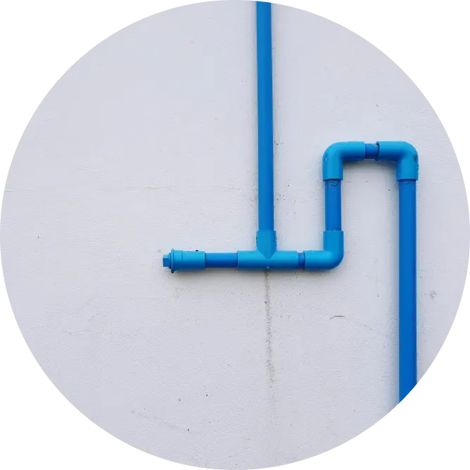 Blue PVC pipe with leakage on the exterior wall of a house. Asian Paints waterproofing products.
