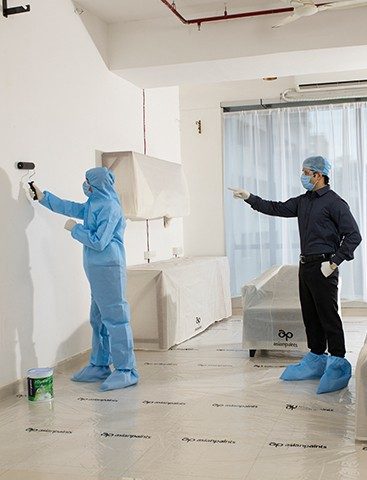 A painting supervisor wearing safety gear in the site.