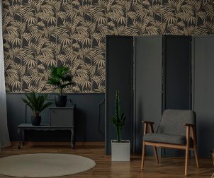 A chair standing in front of a decorative, grey screen next to a
