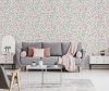 Pink blanket and cushions on grey settee in white flat interior with poster above cupboard. Real photo Pink blanket and cushions on grey settee in white flat interior with poster above cupboard. Real photo