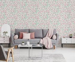 Pink blanket and cushions on grey settee in white flat interior with poster above cupboard. Real photo Pink blanket and cushions on grey settee in white flat interior with poster above cupboard. Real photo