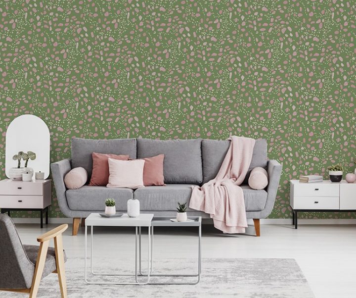 Pink blanket and cushions on grey settee in white flat interior with poster above cupboard. Real photo Pink blanket and cushions on grey settee in white flat interior with poster above cupboard. Real photo