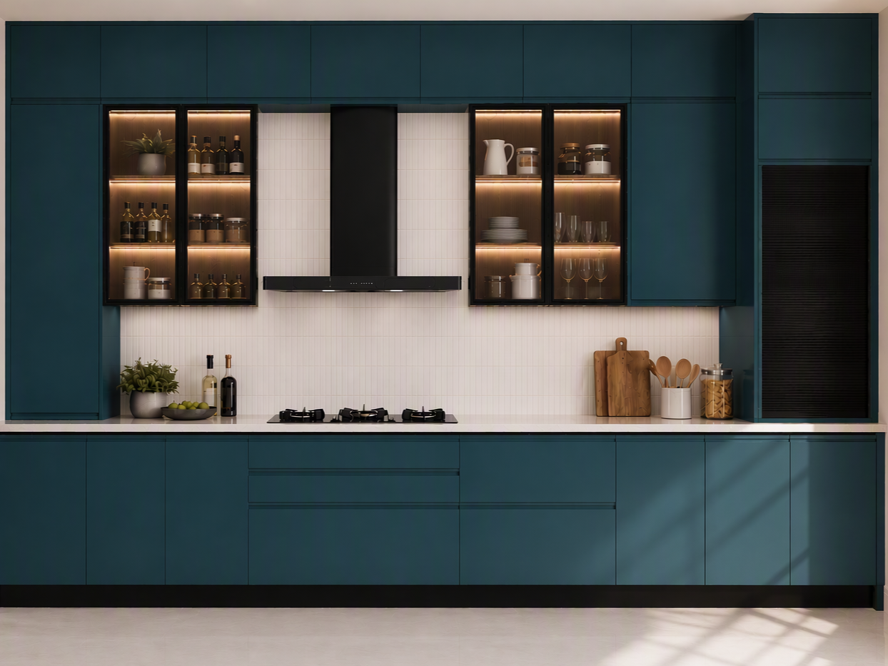 Modern Teal Modular Kitchen with Glass Cabinets and Black Chimney Modern teal-blue modular kitchen featuring illuminated glass display cabinets and a white tiled backsplash - Beautiful Homes