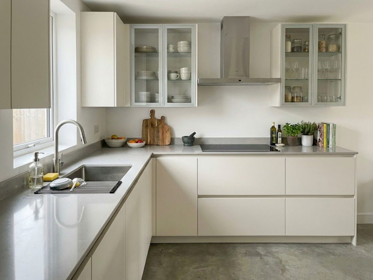 Functional Kitchen with Glass Cabinets Modern L-shaped kitchen with white cabinets and window - Beautiful Homes
