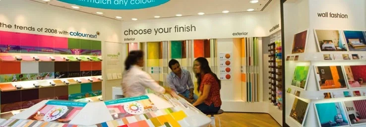 Asian Paints store with customers browsing colour shade cards