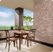 Covered patio with a wooden dining set beside a wall in Apex Ultima Allura stone texture