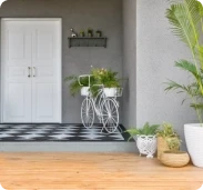 Entrance porch with a white door and grey wall in Apex Ultima Allura stone texture