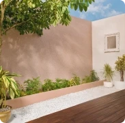Courtyard with a blush pink boundary wall in Apex Ultima Allura stone texture and planters