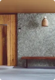 Entrance with a grey stone-look wall in Apex Createx texture and a wooden bench
