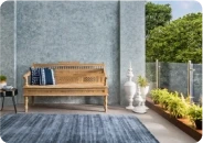 Terrace with a wooden bench against a grey wall in Apex Ultima Allura stone texture