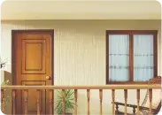 Cream exterior wall in Apex Createx texture with a wooden door, window and balcony railing