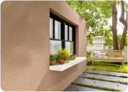 Beige exterior wall in Apex Ultima Allura stone texture with a window and planter box