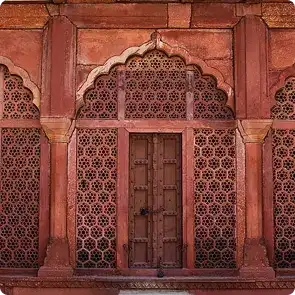 Red sandstone doorway with carved jali screens