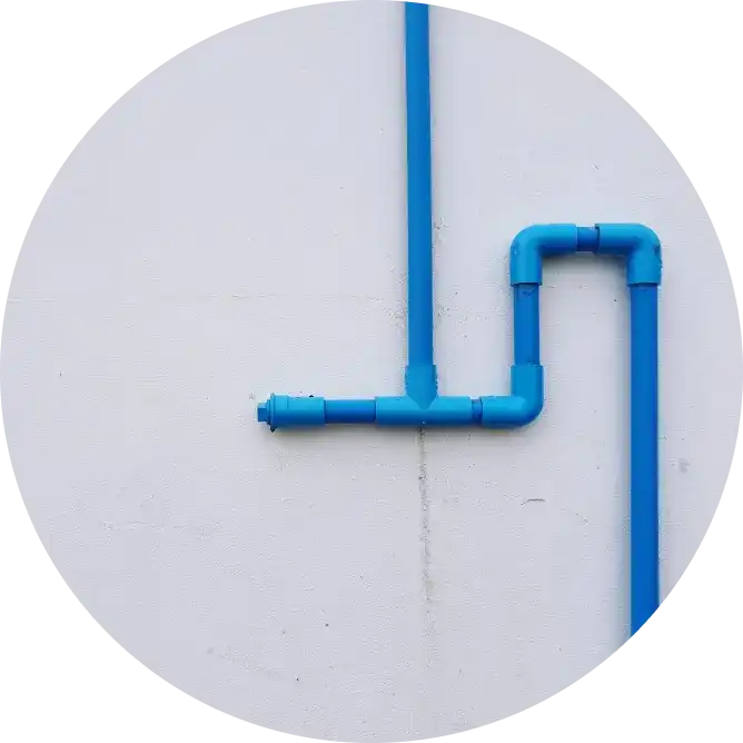Blue PVC pipe with leakage on the exterior wall of a house. Asian Paints waterproofing products.