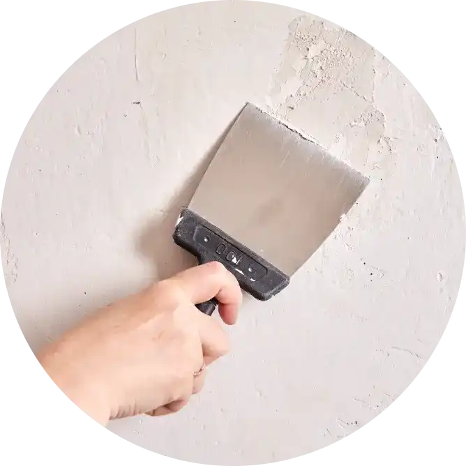 Application of putty on the wall using a painting brush. Asian Paints wall putty collection.